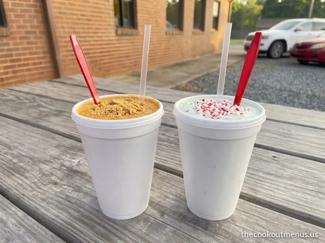 Two seasonal milkshakes in foam cups: pumpkin pie and peppermint chip