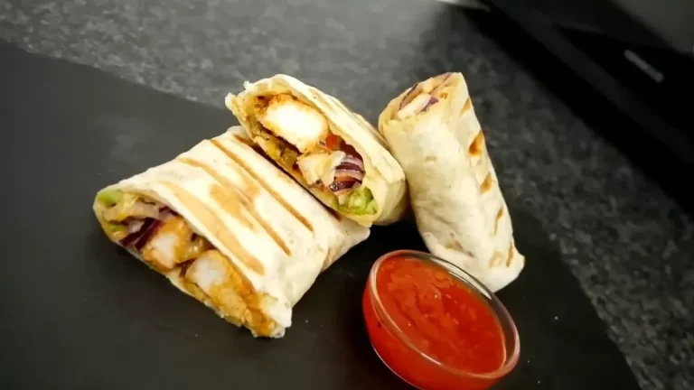 Cookout crispy chicken wraps cut in half with a cup of dipping sauce