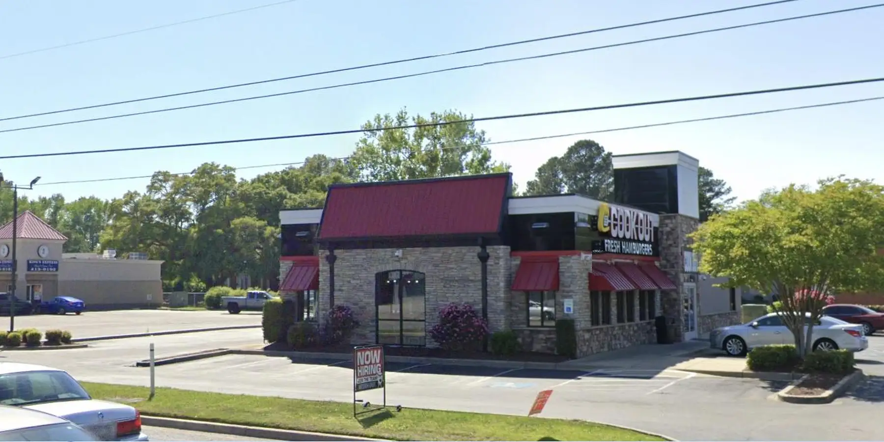 Cook Out restaurant on S Irby St in Florence SC with a stone front, red roof and Cook Out Fresh Hamburgers sign