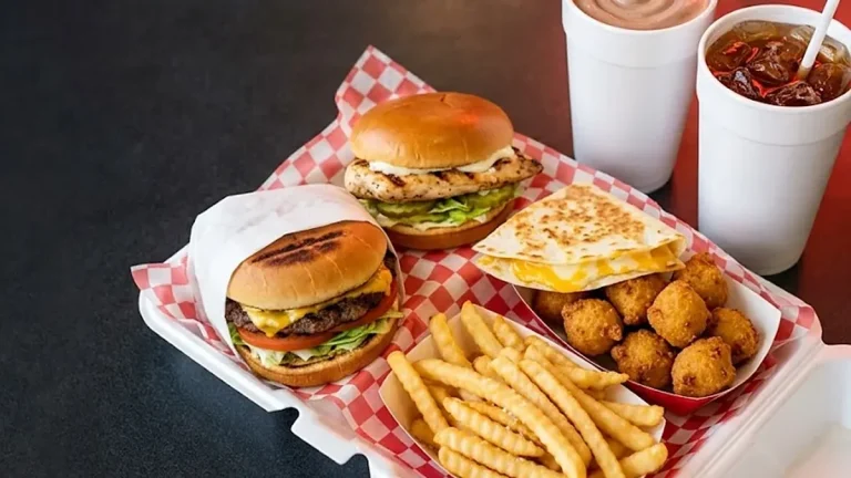 Cookout Tray meal with burgers, chicken sandwich, quesadilla, hushpuppies, fries, a milkshake and sweet tea